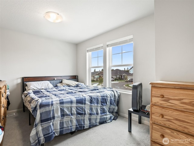 carpeted bedroom with baseboards