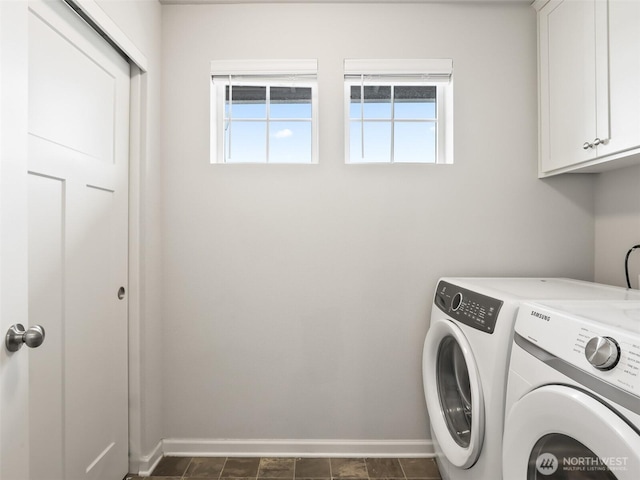 laundry area with cabinet space, plenty of natural light, baseboards, and washer and dryer