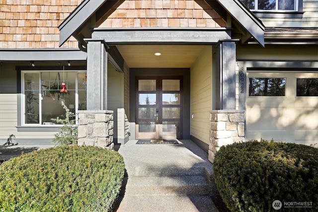 doorway to property with stone siding and french doors