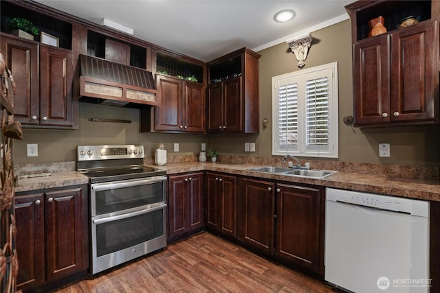 kitchen featuring sink, dark hardwood / wood-style floors, white dishwasher, custom range hood, and range with two ovens