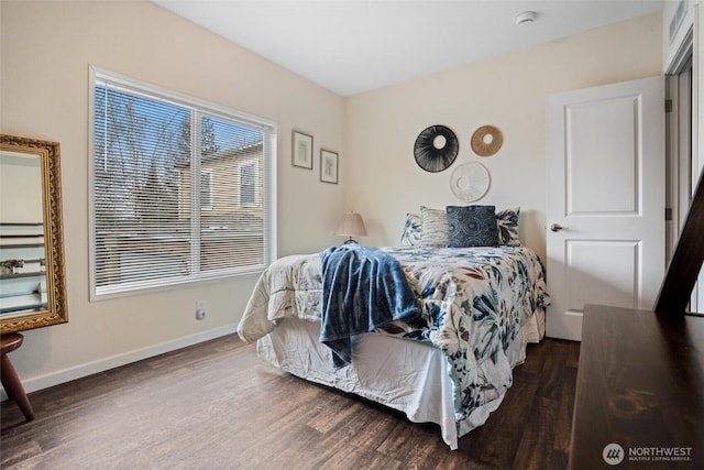 bedroom with dark hardwood / wood-style floors