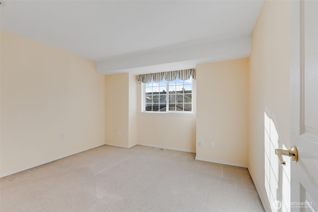 unfurnished room with light colored carpet