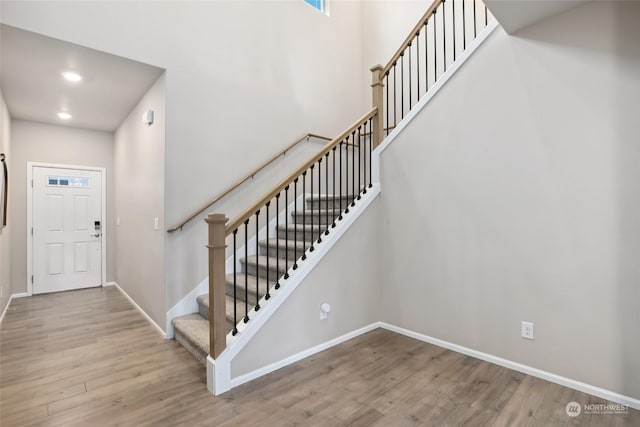 entrance foyer with hardwood / wood-style flooring and a high ceiling