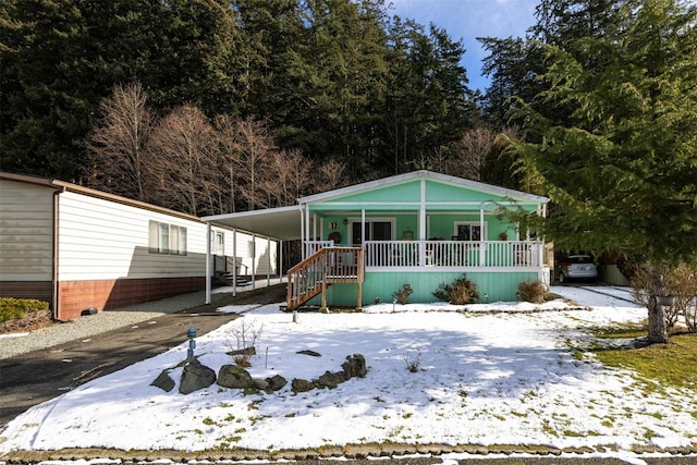 view of front of property with a porch and a carport