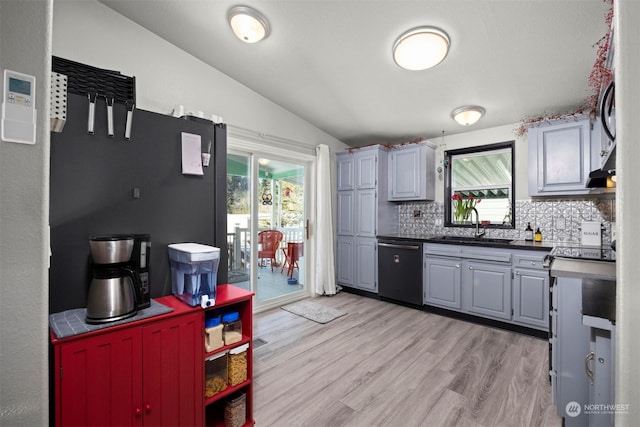 kitchen with gray cabinets, a wealth of natural light, dishwashing machine, and light hardwood / wood-style flooring