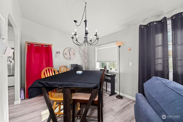 dining room with a chandelier and light hardwood / wood-style flooring