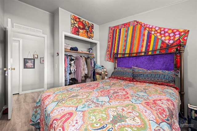 bedroom with hardwood / wood-style flooring and a closet