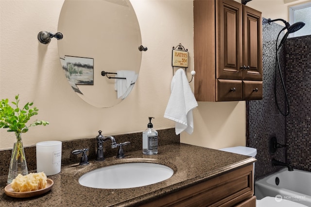 full bathroom featuring vanity, bathtub / shower combination, and toilet