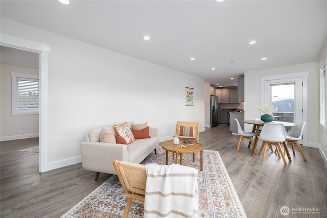 living area featuring recessed lighting, wood finished floors, and a healthy amount of sunlight