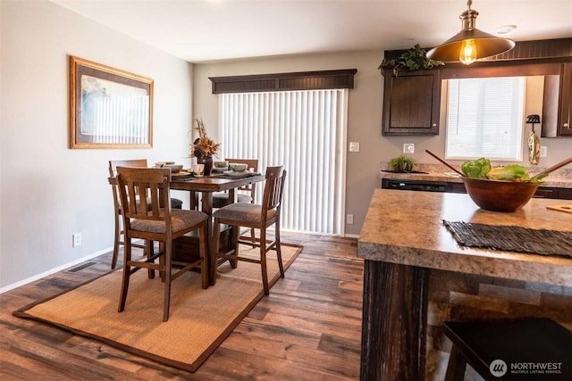 dining space with dark hardwood / wood-style flooring