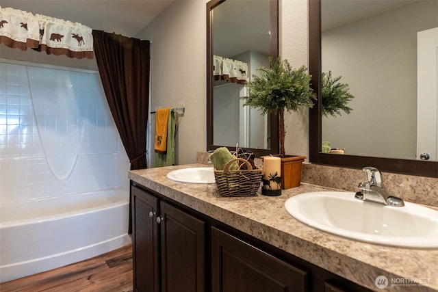 bathroom featuring hardwood / wood-style flooring, shower / bath combo, and vanity