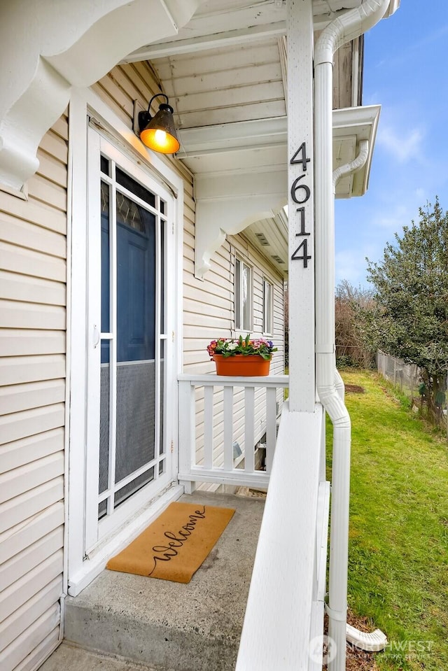 doorway to property featuring a yard