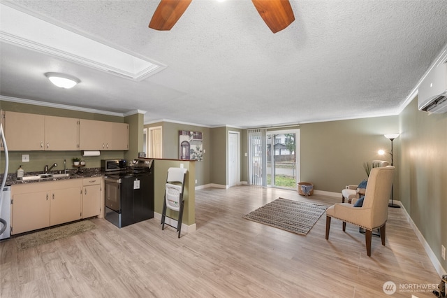 kitchen featuring ornamental molding, black range with electric stovetop, light wood-type flooring, and cream cabinetry