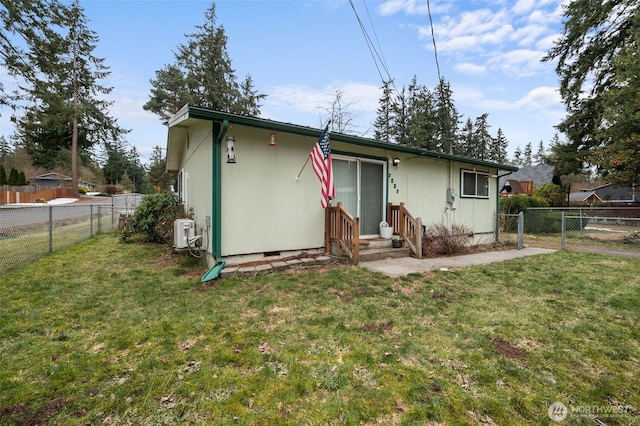 back of house with a lawn