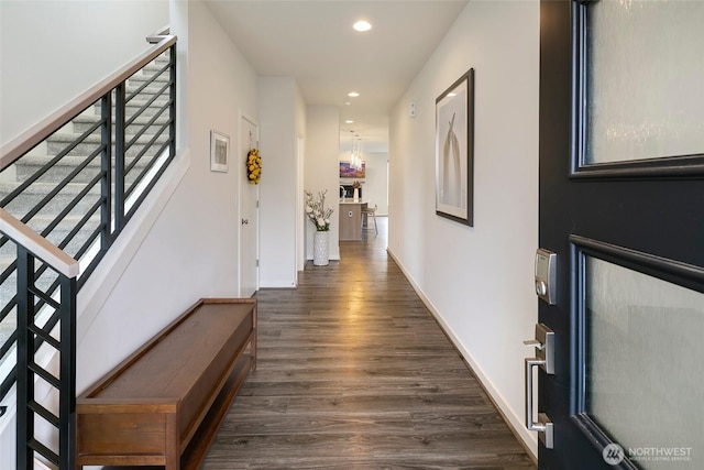 corridor featuring stairs, dark wood-style flooring, baseboards, and recessed lighting