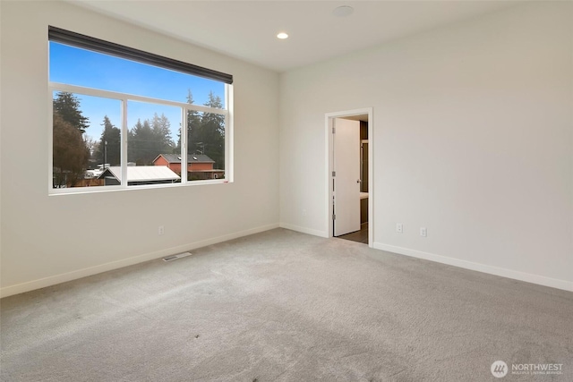 carpeted empty room with recessed lighting, visible vents, and baseboards