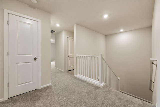 hallway with light colored carpet