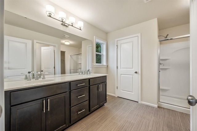 bathroom featuring vanity and a shower with door