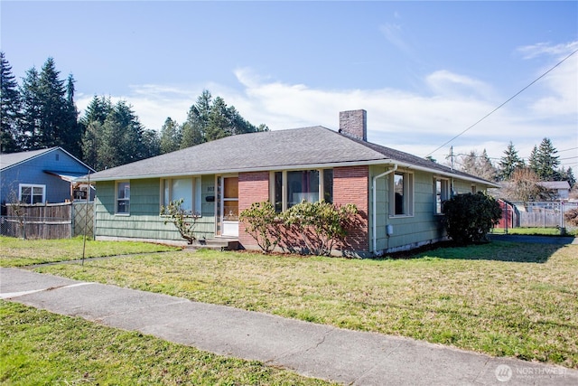 single story home with a chimney, roof with shingles, fence, a front lawn, and brick siding