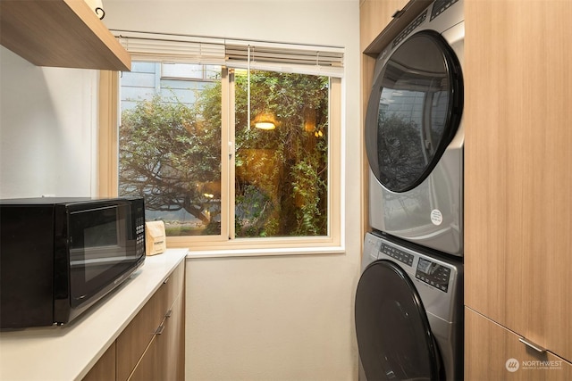 washroom with stacked washer and dryer