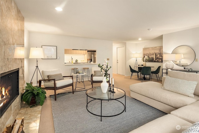 living room featuring a tiled fireplace