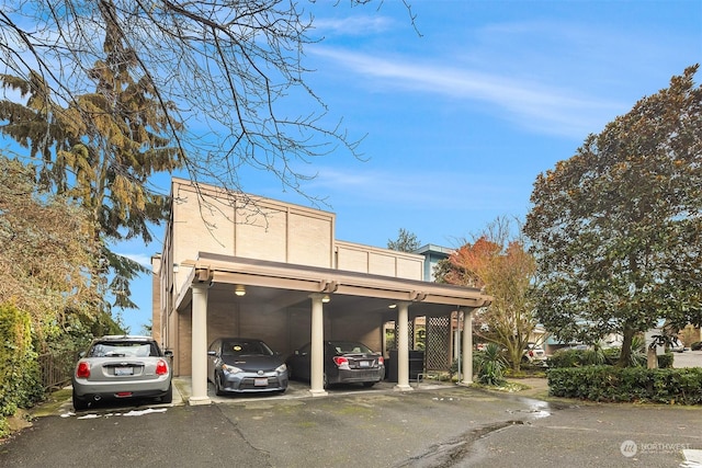 view of vehicle parking featuring a carport