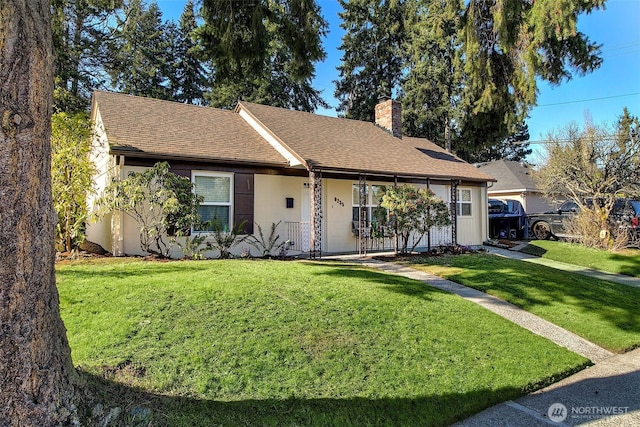 ranch-style house featuring a porch and a front yard