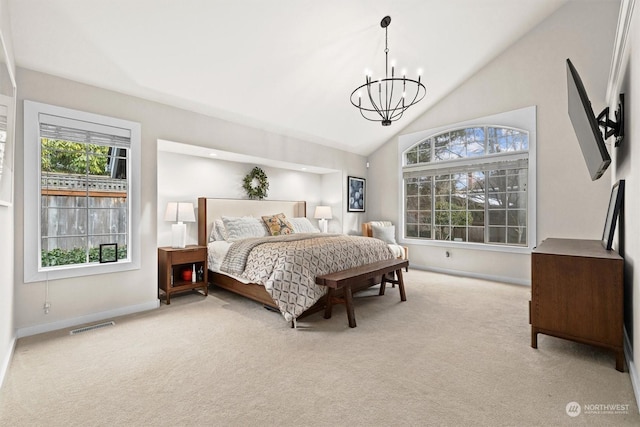 carpeted bedroom with multiple windows, a notable chandelier, and high vaulted ceiling