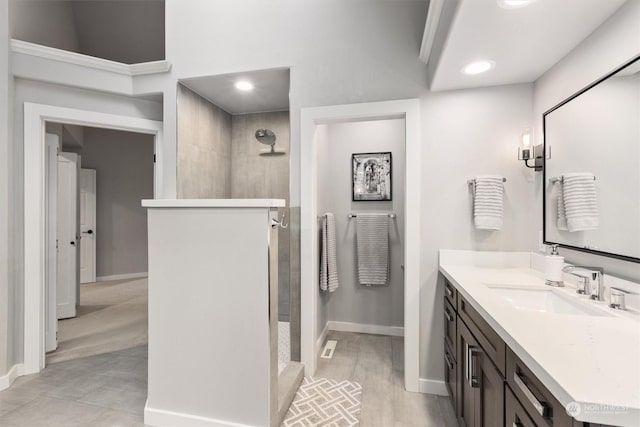 bathroom featuring vanity and tiled shower