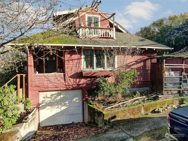 view of front of property with a garage and a balcony