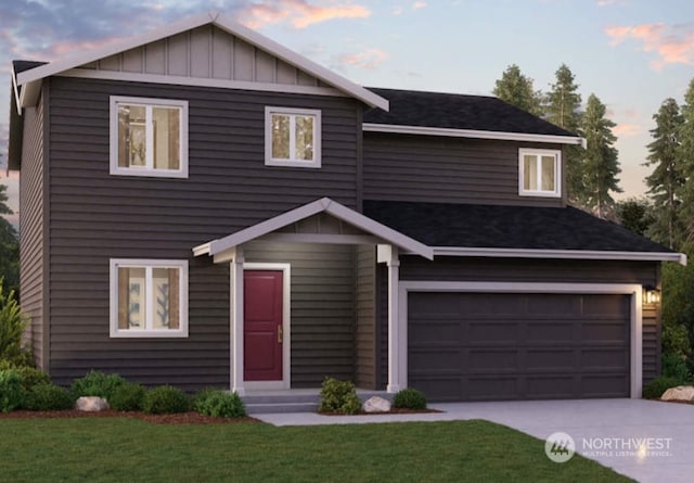 view of front of home with board and batten siding, a garage, driveway, and a front lawn