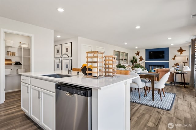 287 Wind River Ct, Chehalis, WA 98532 - kitchen featuring a large fireplace, wood finished floors, a sink, white cabinets, and stainless steel dishwasher