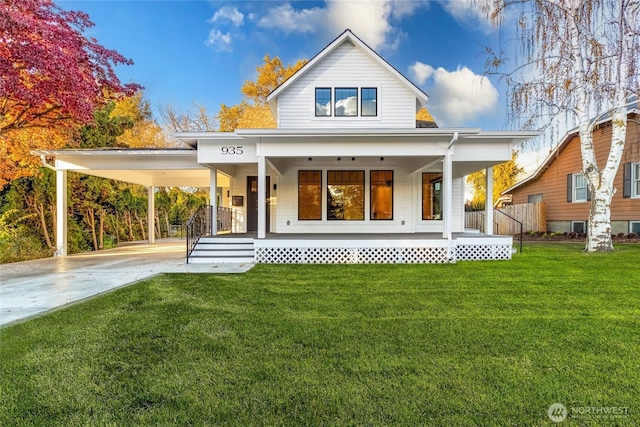 rear view of property with driveway, a porch, a carport, and a yard