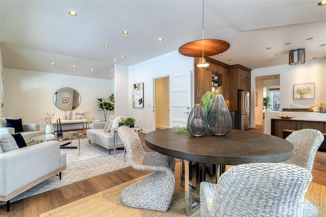 dining space with recessed lighting and light wood-style floors