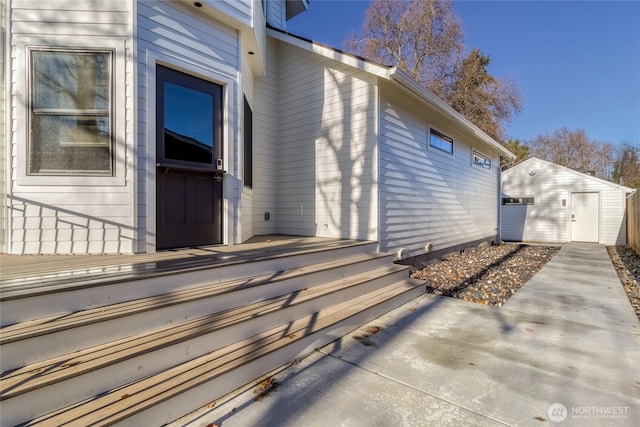 view of property exterior with a patio area and an outdoor structure