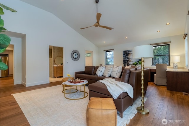 living room with baseboards, ceiling fan, wood finished floors, high vaulted ceiling, and recessed lighting