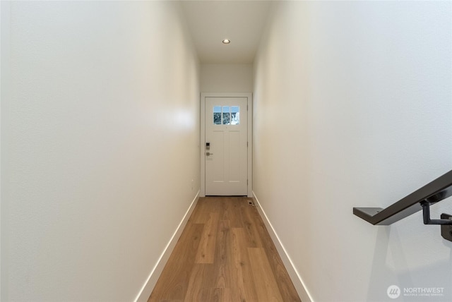 hall featuring recessed lighting, light wood-style flooring, and baseboards