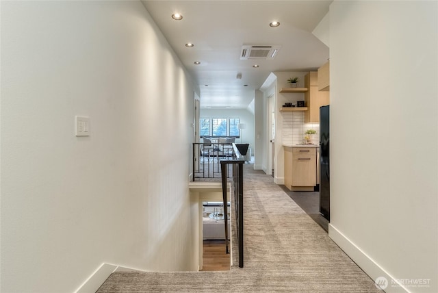 corridor with visible vents, baseboards, dark colored carpet, an upstairs landing, and recessed lighting