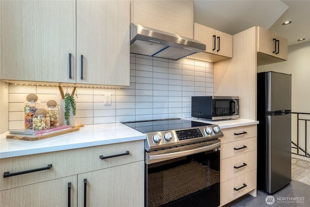 kitchen with recessed lighting, light countertops, backsplash, appliances with stainless steel finishes, and extractor fan