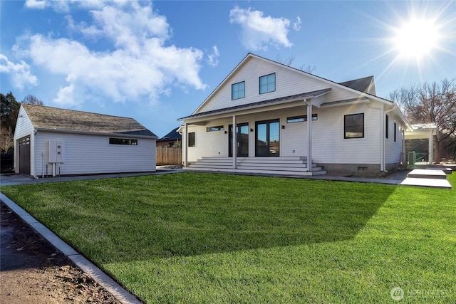 view of front of home featuring a front yard, crawl space, covered porch, and an outbuilding