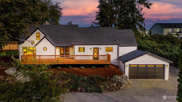 view of front of home with a wooden deck and a garage