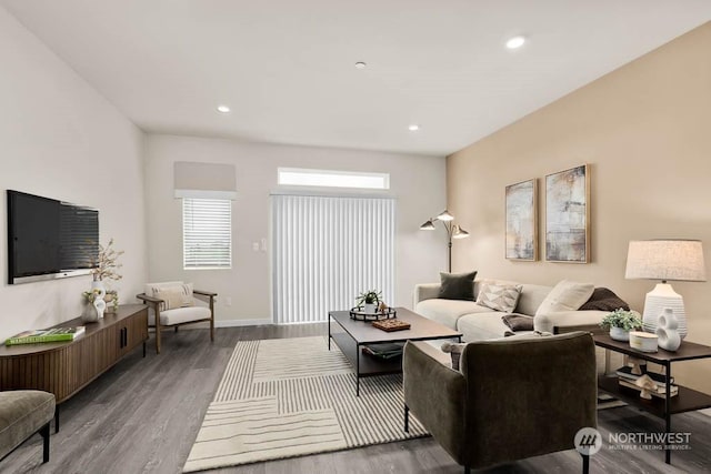 living area with baseboards, wood finished floors, and recessed lighting