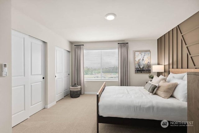 carpeted bedroom featuring baseboards