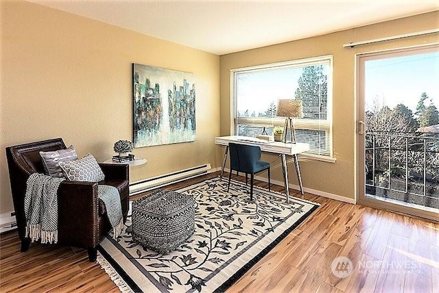 office space featuring a baseboard radiator and light wood-type flooring