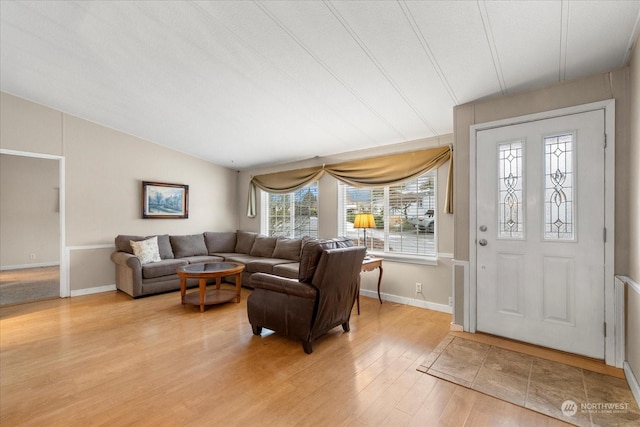 living room with hardwood / wood-style flooring, vaulted ceiling, and a textured ceiling