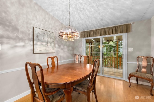 dining space with an inviting chandelier and light hardwood / wood-style flooring