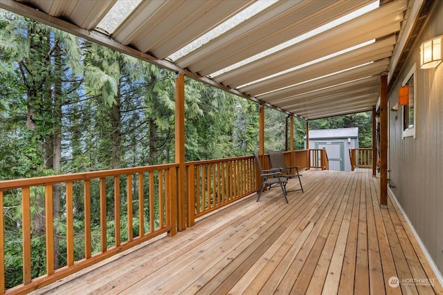 wooden terrace featuring a shed