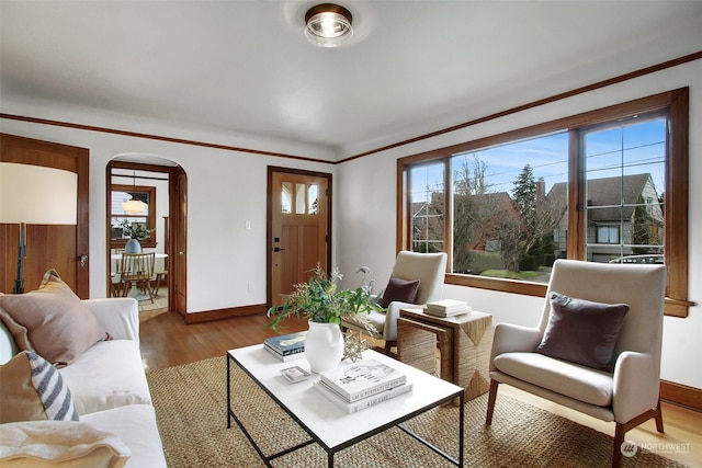 living room featuring crown molding and hardwood / wood-style floors