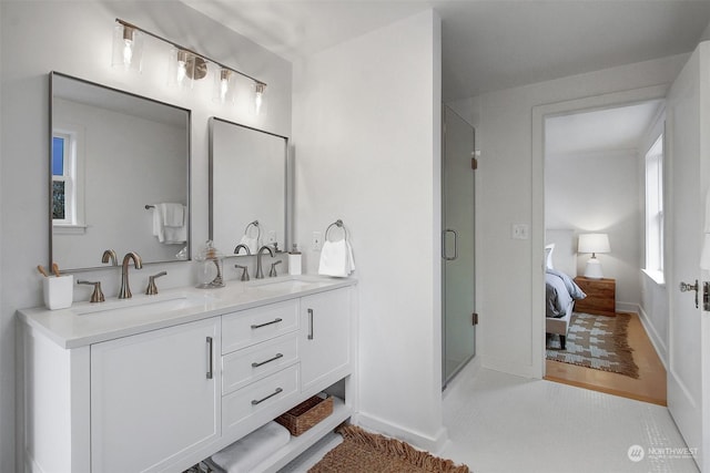 bathroom featuring vanity and a shower with shower door