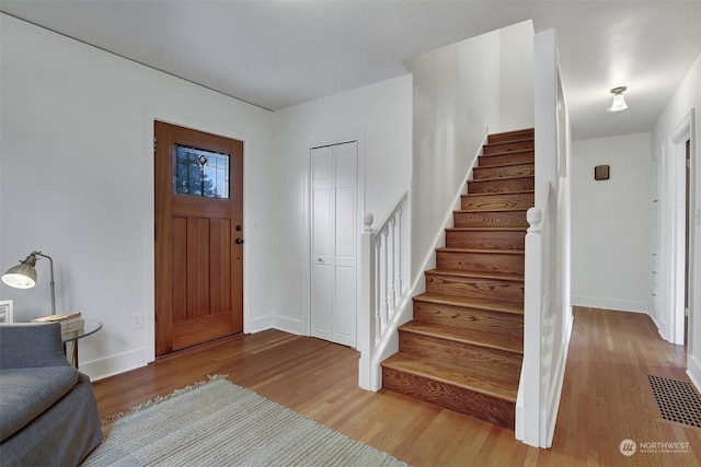 entryway with hardwood / wood-style floors